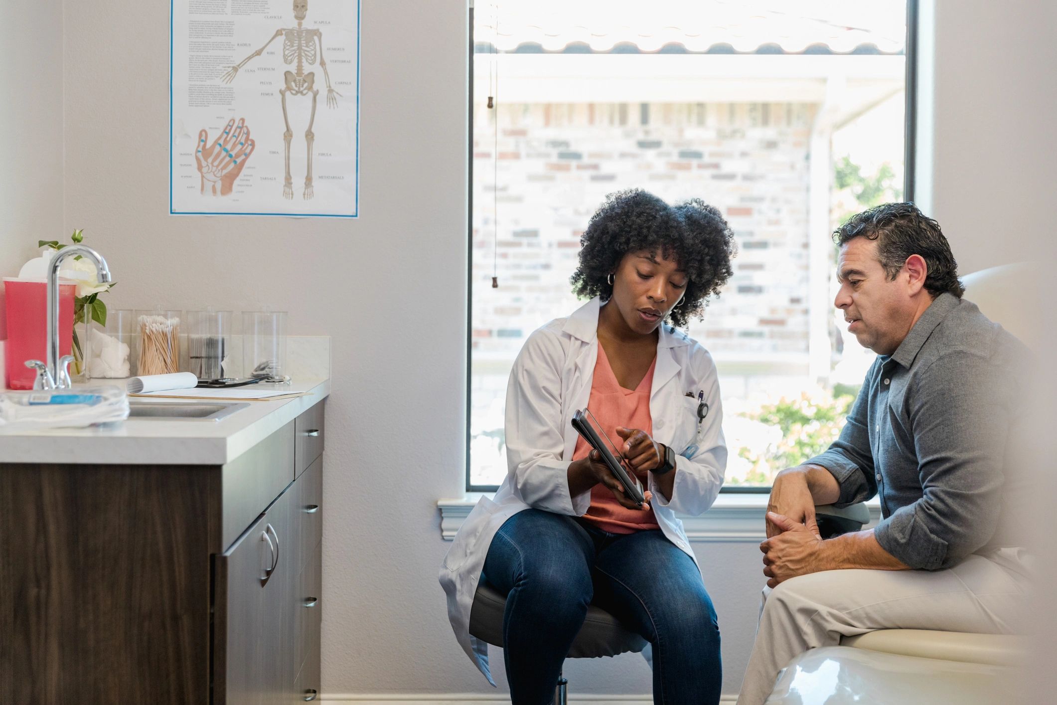 Doctor reviewing information with a patient on a tablet