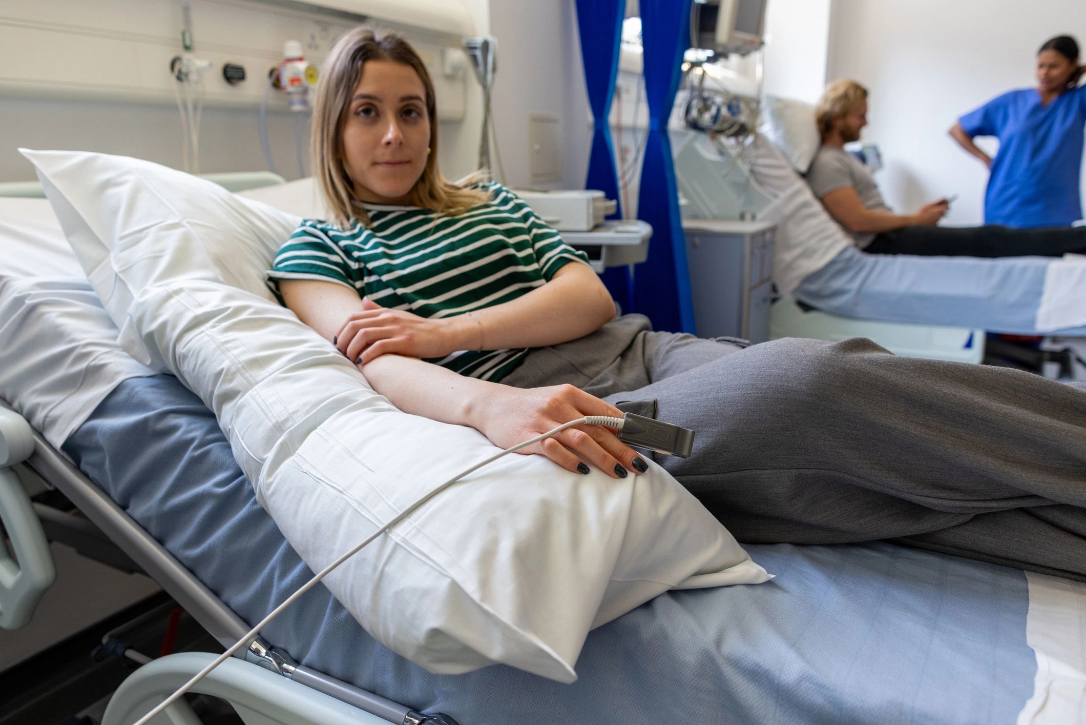 Patient wearing a finger oximeter while awaiting lab results